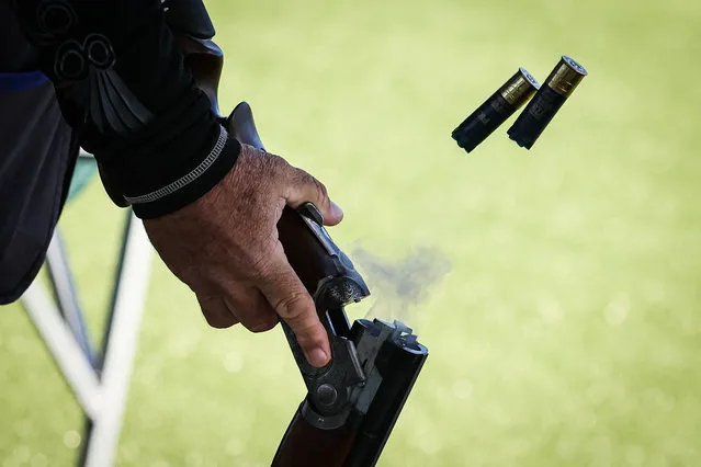 Cartridges are ejected from a gun during a trap shooting competition as part of a test event ahead of the Paris 2024 Olympic Games shooting event at the French National Shooting Centre (CNTS), in Deols, near Chateauroux, central France on April 9, 2024. (Photo by Alain Jocard/AFP Photo)