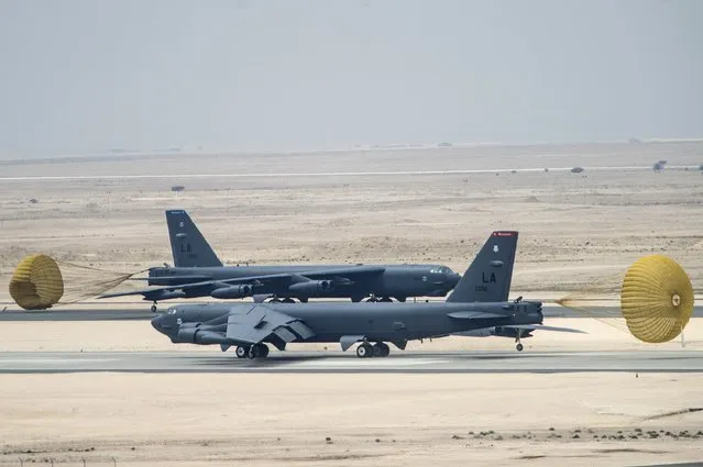 A pair of U.S. Air Force B-52 Stratofortress bombers from Barksdale Air Force Base, Louisiana, taxi after landing at Al Udeid Air Base, Qatar, April 9, 2016. The U.S. Air Force deployed B-52 bombers to Qatar on Saturday to join the fight against Islamic State in Iraq and Syria, the first time they have been based in the Middle East since the end of the Gulf War in 1991. (Photo by Staff Sgt. Corey Hook/Reuters/U.S. Air Force)