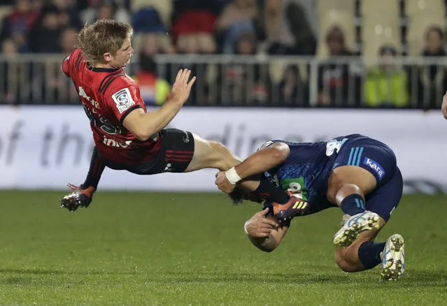 Crusaders Jack Goodhue, left, is airborne as he is tackled by Blues Levi Aumua during their Super Rugby match in Christchurch, New Zealand, Saturday, May 25, 2019. (Photo by Mark Baker/AP Photo)