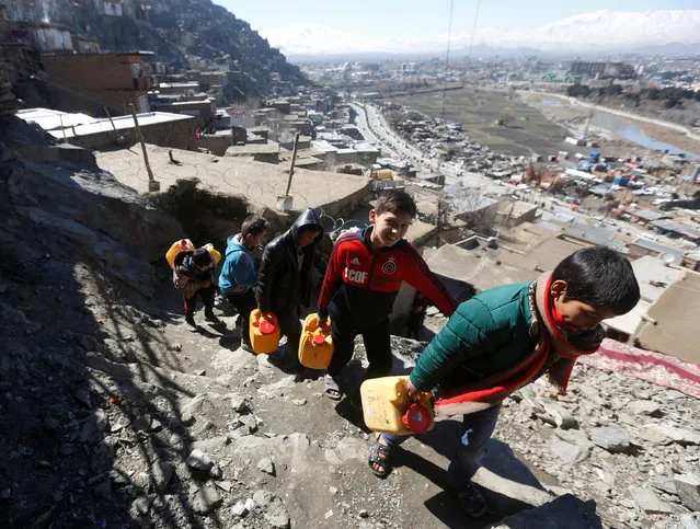 Afghan boys carry water as they climb a hill in Kabul, Afghanistan February 20, 2017. A growing population is straining water supplies in Afghanistan's capital, forcing those who can afford it to dig unregulated wells ever deeper to tap a falling water table. Finding water in arid Afghanistan is virtually always a challenge, but a drop in the groundwater level in Kabul caused by overuse and drought is making it even more difficult for residents, especially the poor. Modern Kabul was originally planned to support about 1 million people, but is now home to more than 4.6 million, according to U.S. government estimates, with people fleeing violence and seeking jobs thronging into urban centers. Several unseasonably dry winters, with little rain and a dusting of snow, have exacerbated the problem. Heavy rain and snow this year has raised hopes that groundwater can be replenished, at least for a while. Since 2001, Kabul's sprawl has expanded by nearly 2,500 square kilometers (965 square miles), according to the World Bank, with some of the poorest arrivals perched in homes on rocky hills around the city, where wells are generally non-existent. At the base of the hills, children cluster around hand-operated pumps, filling buckets and cans before climbing back up to their homes. People who can afford it usually dig a well rather than depending on the city's limited water system, but they are having to go ever deeper to reach the receding water. The depth of a well varies across the city, but Khan said many residents are being forced to dig 10 to 20 meters (32-64 feet) deeper than in the past. In some cases, wells have to go down 150 meters (492 feet) or more to reach clean water, at a cost of more than $5,200, he said, a price out of reach of many people. Officials say well digging has spiraled out of control, with little or no regulation of how the ever more scarce water is exploited. In the past, residents have been banned from digging wells within 100 meters (328 feet) of each other, but wells are now routinely dug 5 to 10 meters (16-32 feet) apart, sucking ever more water from the aquifers. The government was looking to implement a licensing system. The ministry of water and power did not respond to requests for comment. Poor residents are not optimistic authorities will get a grip on the problem, at least in a way that will help them get better access. (Photo by Omar Sobhani/Reuters)