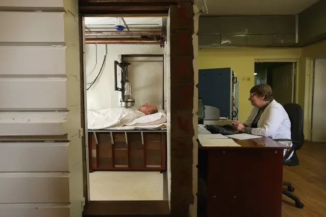 Artur Vlasenko, 27, who is applying for a job at the Chernobyl nuclear power plant, prepares to undergo screening for radiation levels, April 7, 2016, in Kiev, Ukraine. The National Research Center for Radiation Medicine is a hospital and research institute that was established after the 1986 Chernobyl nuclear accident. (Photo by Sean Gallup/Getty Images)