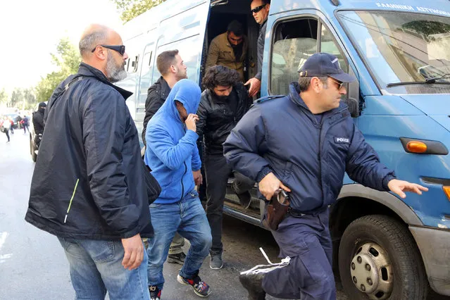 Suspected members of an international criminal organization smuggling undocumented migrants to European countries are transferred to the prosecutor after being arrested at the city of Heraklion on the island of Crete, Greece, March 4, 2017. (Photo by Stefanos Rapanis/Reuters)