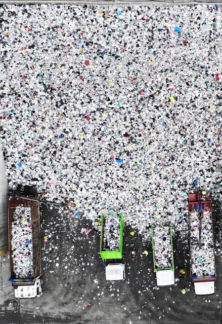 Work is under way to move piles of plastic waste at a facility that stores recyclable materials in Suwon, South Korea, 22 April 2024, Earth Day. (Photo by Yonhap/EPA)