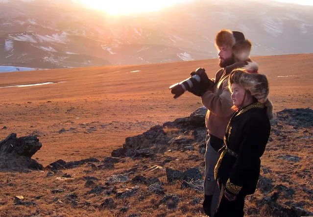 Photographer Asher Svidensky (rear) with 13 year old Ashol Pan) – These stunning photographs show the changing face of a majestic centuries old Kazakh pastime tradition  that still lives in the lands of mongolia - eagle hunters. (Photo by Asher Svidensky/Caters News)