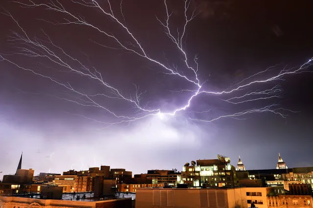 Lightning brightens the night sky over Washington, DC, during a rainstorm on April 20, 2015. (Photo by Mladen Antonov/AFP Photo)