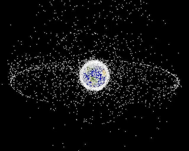 A computer-generated images of objects in Earth orbit that are currently being tracked. Approximately 95% of the objects in this illustration are orbital debris, i.e., not functional satellites. The dots represent the current location of each item. The orbital debris dots are scaled according to the image size of the graphic to optimize their visibility and are not scaled to Earth. (Photo by NASA)
