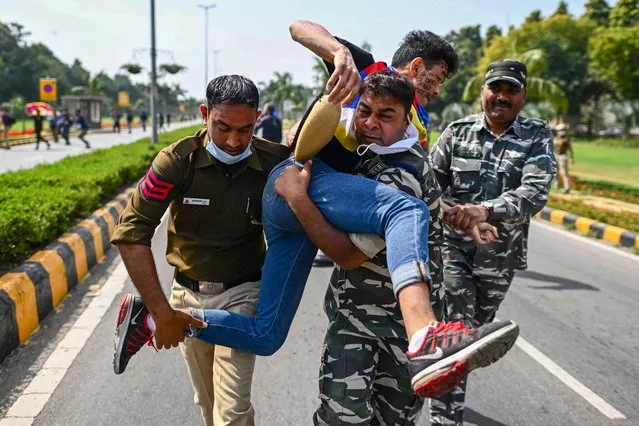 Police detain a protester during a demonstration near the Chinese embassy to mark the 63rd Tibetan uprising anniversary in New Delhi on March 10, 2022. (Photo by Jewel Samad/AFP Photo)