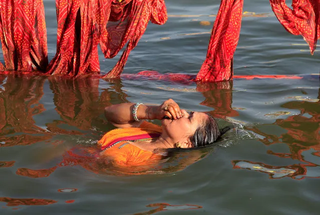 A Hindu devotee takes a holy dip in the Shipra river at the Simhastha Kumbh Mela in Ujjain, India, May 20, 2016. (Photo by Jitendra Prakash/Reuters)