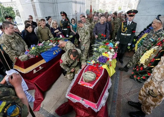 Servicemen take part in a funeral ceremony for Mykola Kuliba and Serhiy Baula, servicemen from the “Aydar” battalion, who were killed in the fighting in eastern Ukraine, at Independence Square in central Kiev, Ukraine, May 26, 2016. (Photo by Gleb Garanich/Reuters)