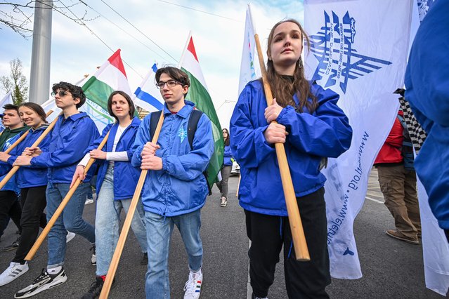 Young volunteers hold their flags as they take part in a “March of the Living Hungary” in Budapest on April 16, 2023. The 2023 March of the Living celebrates the 75th anniversary of the State of Israel, the 80th anniversary of the Warsaw Ghetto Uprising and 35th anniversary of the March of the Living. (Photo by Attila Kisbenedek/AFP Photo)