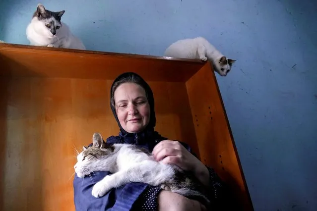 Nun Varvara holds a cat at the Saint Michael the Archangel's women monastery (Sviatyi Arkhanhelo-Mykhailivskyi), where they rescue cats left behind by their owners in Odesa, Ukraine, April 7, 2022. (Photo by Igor Tkachenko/Reuters)