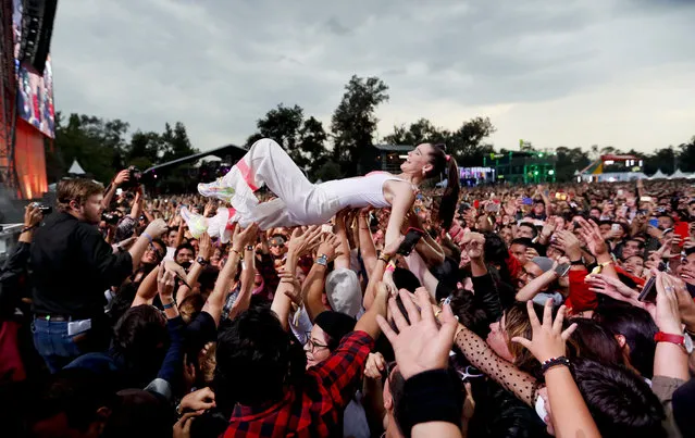 Sophie Hawley-Weld, of German-American musical duo Sofi Tukker, crowd surfs with fans during the Corona Capital music festival in Mexico City, Sunday, November 17, 2019. (Photo by Eduardo Verdugo/AP Photo)