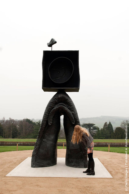 A woman admires Joan Miro's sculpture, Personnage Gothique, Oiseau Eclaie (1976) stands in the Yorkshire Sculptire park
