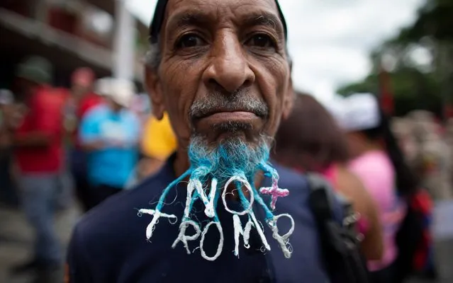 A supporter of President Nicolas Maduro has his beard done with the words “No more Trump” during an anti-imperialist rally in Caracas, Venezuela, Saturday, August 31, 2019. (Photo by Ariana Cubillos/AP Photo)