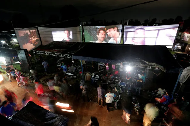 People watch films during a wedding party in Bogor, Indonesia, March 19, 2017. (Photo by Reuters/Beawiharta)