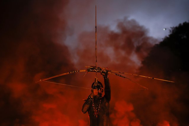 A member of Guarani Mbya Indigenous people uses a bow and arrow during a protest against the so-called legal thesis of “Marco Temporal” (Temporal Milestone) as they close the Bandeirantes highway in Sao Paulo, Brazil on May 30, 2023. (Photo by Amanda Perobelli/Reuters)