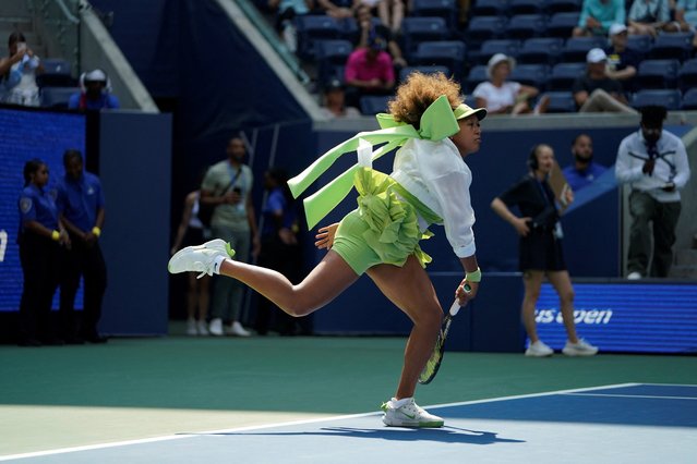 Japan's Naomi Osaka warms up before her women's singles first round match against Latvia's Jelena Ostapenko on day two of the US Open tennis tournament at the USTA Billie Jean King National Tennis Center in New York City, on August 27, 2024. Osaka stole the show at the US Open when she appeared on court sporting a giant, bright green bow on the back of her jacket before peeling off an equally colourful tutu. The Japanese star's outfit drew immediate comparisons with fellow Grand Slam queen Serena Williams who also backed up her brash choice of clothes with an equally confident game on court. (Photo by Timothy A. Clary/AFP Photo)
