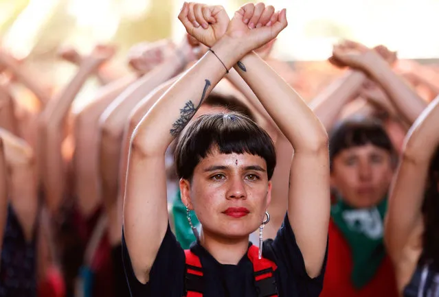 Dafne Valdes, from the feminist collective LasTesis performs the choreography “A rapist in your path”, together with a group of women, after participating in a discussion on the role of art and culture in the social protests of the country, in Santiago, Chile, 12 December 2019. What was going to be a small street performance in the port city of Valparaiso, “a rapist in your path” ended up becoming a global anthem against sexual violence that has been sung even in countries as hostile to women as India or Lebanon. (Photo by Alberto Valdés/EPA/EFE)
