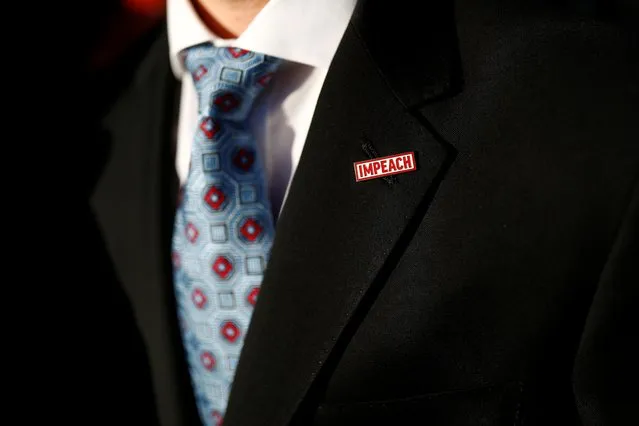 A man wears a lapel pin reading “Impeach” as activists rally in support of the impeachment of U.S. President Donald Trump on Capitol Hill in Washington, U.S., December 18, 2019. (Photo by Tom Brenner/Reuters)