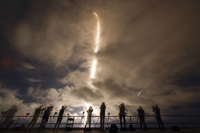 A time exposure shows photographers as they document the SpaceX Falcon 9 rocket with a crew of four as it launches from pad 39A at the Kennedy Space Center in Cape Canaveral, Fla., Monday, September 9, 2024. (Photo by John Raoux/AP Photo)