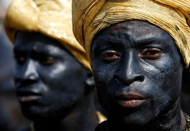 Participants from the Ivorian ethnic group Adjoukrou look on during the parade for the launch of MASA (Abidjan Performing Arts Market), in a street in Yopougon, in Abidjan, Ivory Coast, March 4, 2022. (Photo by Luc Gnago/Reuters)