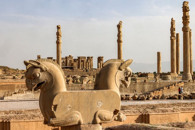 This picture taken on May 13, 2024 shows a view of a sculpture of the mythical “Huma” double griffin in the ruins of ancient Persepolis, which served as the capital of the Achaemenid Persian Empire (550-330 BC), in southern Iran. Conservationists at Persepolis, Iran's most iconic ancient site, are waging a delicate battle against a tiny but persistent adversary: the lichen, a symbiotic organism that grows on surfaces like stone eroding millenia-old monuments, in a fight to preserve the integrity of the site's structures and its intricate carvings. (Photo by Atta Kenare/AFP Photo)