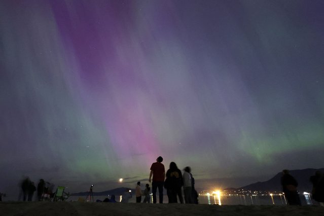 The aurora borealis, also known as the “northern lights”, caused by a coronal mass ejection on the Sun, illuminates the sky over Jericho Beach in Vancouver, British Columbia, Canada on May 10, 2024. (Photo by Chris Helgren/Reuters)