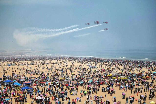 Sarang Helicopter Display Team of the Indian Air Force (IAF) perform an airshow during celebrations ahead of the Indian Air Force day at Marina beach in Chennai on October 6, 2024. (Photo by R. Satish Babu/AFP Photo)