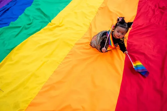 A child holds a rainbow flag during a Pride March in Pasay City, Metro Manila, Philippines, June 25, 2022. (Photo by Lisa Marie David/Reuters)