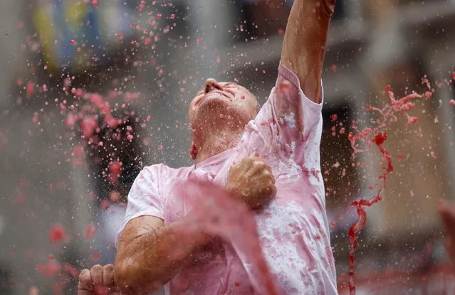 A reveller takes part in an opening of the San Fermin festival in Pamplona, Spain on, July 6, 2022. (Photo by Juan Medina/Reuters)