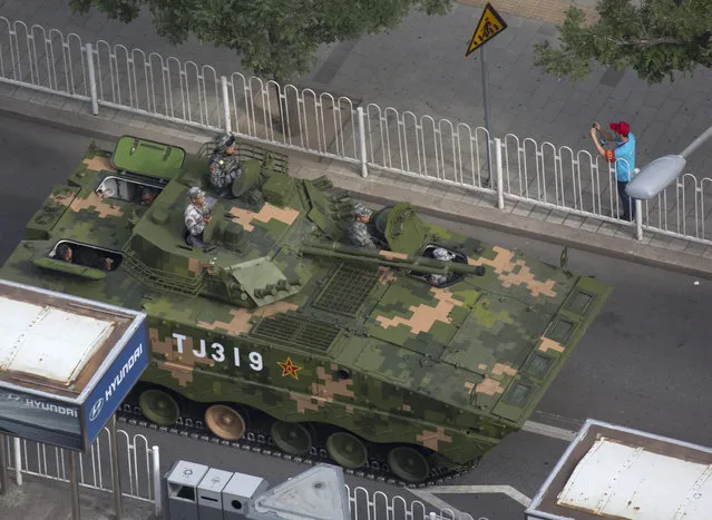 A Chinese armored fighting vehicle leaves after rehearsals ahead of the Sept. 3 military parade to commemorate the end of World War II in Beijing, Sunday, August 23, 2015. (Photo by Ng Han Guan/AP Photo)