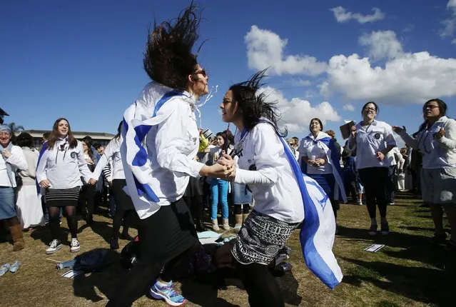 Pro-Israeli activists dance as they gather at Barracluff Park in North Bondi on August 3, 2014 in Sydney, Australia. Pro-Israeli supporters gathered to to condemn Palestinian efforts in Gaza where reportedly 63 Israeli and over 1,650 Palestinians have been killed during the past three weeks of unrest. (Photo by Daniel Munoz/Getty Images)