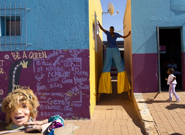 Stilt walker Andile Sohe (32) and Miss Preteen Orange Farm, Thando Mbatha (7), prepare for the annual Orange Farm Carnival, in Johannesburg, South Africa, 01 December 2024. The annual festival aims to bring the community of the township south of Johannesburg together in a spirit of 'Ubuntu', or togetherness. Organized by the Project of Nkosana Ngobese Foundation in Association with the Stretford CHC Clinic, the carnival also raises awareness to the subject of HIV/AIDS and the 16 days of activism highlighting gender-based violence in the community. (Photo by Kim Ludbrook/EPA/EFE)