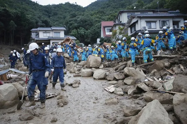 Police officers search for survivors at the site of a landslide at Asaminami ward in Hiroshima  August 20, 2014. At least 36 people, including several children, were killed in Japan on Wednesday, when landslides triggered by torrential rain slammed into the outskirts of the western city of Hiroshima, and the toll could rise further, police said. (Photo by Toru Hanai/Reuters)