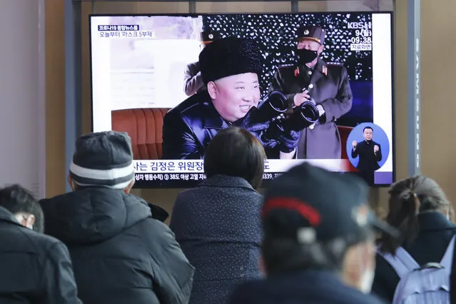 People watch a TV showing a file image of North Korean leader Kim Jong Un during a news program at the Seoul Railway Station in Seoul, South Korea, Monday, March 9, 2020. North Korea fired three unidentified projectiles off its east coast on Monday, South Korea's military said, two days after the North threatened to take “momentous” action to protest outside condemnation over its earlier live-fire exercises. (Photo by Ahn Young-joon/AP Photo)