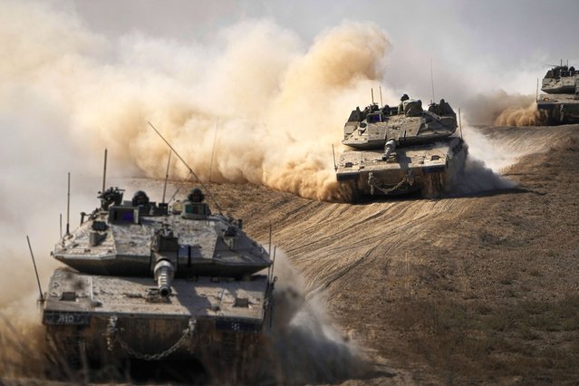 Israeli tanks head towards the Gaza Strip border in southern Israel on Friday, October 13, 2023. (Photo by Ariel Schalit/AP Photo)