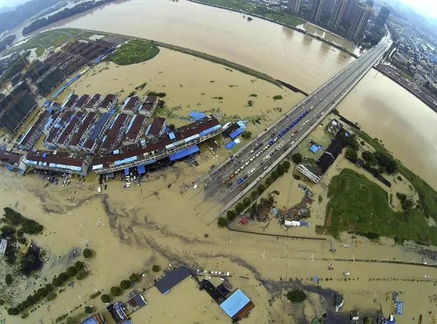An aerial view shows a flooded highway after heavy rainfall hit Lishui, Zhejiang province, August 20, 2014. (Photo by Reuters/Stringer)