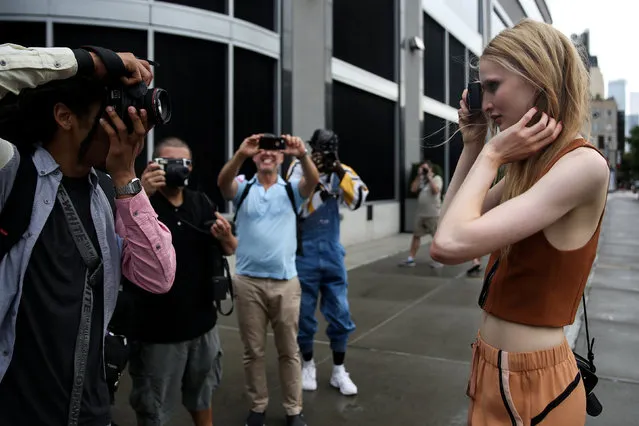 A model takes a photograph of photographers during New York Fashion Week in the Manhattan borough of New York City, U.S., September 13, 2017. (Photo by Amr Alfiky/Reuters)