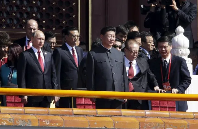 Former Chinese President Jiang Zemin (R) is helped to his place during a military parade to mark the 70th anniversary of the end of World War Two, with China's President Xi Jinping (C), Russia’s President Vladimir Putin (L) and China's Premier Li Keqiang, in Beijing, China, September 3, 2015. (Photo by Jason Lee/Reuters)
