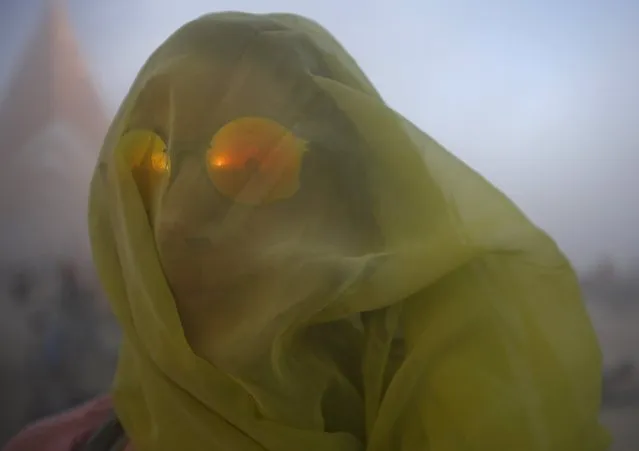 Meryl Livermore covers her head with a scarf during a dust storm at the Burning Man 2015 “Carnival of Mirrors” arts and music festival in the Black Rock Desert of Nevada, September 2, 2015. (Photo by Jim Urquhart/Reuters)