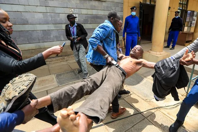 A Kenyan activist Julius Kamau (C) is dragged out after he went to shout slogans inside a media center as Kenya's Supreme Court judges led by the Chief Justice Martha Koome (not seen) held a Pre-Trial session of the presidential petition filed by the opposition leader Raila Odinga, challenging the outcome of the 9th August presidential elections that Deputy President William Ruto was declared the President-elect at the Milimani Law Courts in Nairobi, Kenya, 30 August 2022. (Photo by Daniel Irungu/EPA/EFE/Rex Features/Shutterstock)