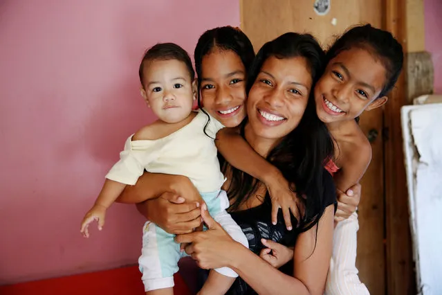 Geraldine Rocca, 29, (2nd R) poses for a picture with her children (L-R) Jeremy, Nicole and Janna, ahead of her sterilization surgery in Caracas, Venezuela July 20, 2016. (Photo by Carlos Garcia Rawlins/Reuters)