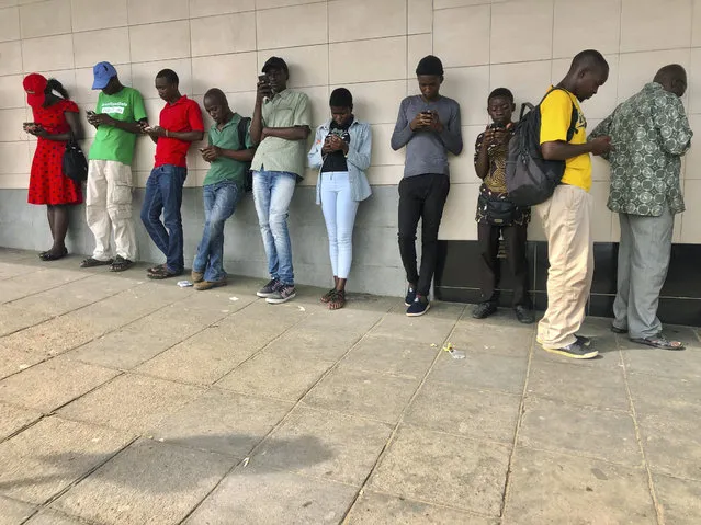 People acesss free wifi on their mobile phones at a public spot in Mutare, Saturday, November 23, 2019, about 270 kilometres east of the capital, Harare, Zimbabwe. According to a latest independent report, Zimbabwe has one of the worlds most expensive mobile data. The high cost of data has been mainly attributed to the fact that the country has relatively fewer mobile internet providers and that it is landlocked. (Photo by Tsvangirayi Mukwazhi/AP Photo)