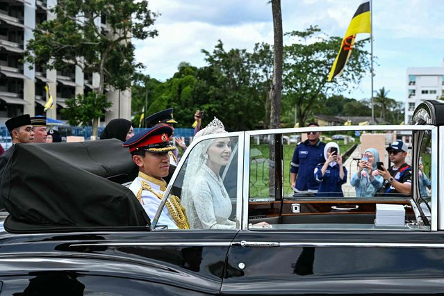 Prince Abdul Mateen and Yang Mulia Anisha Rosnah sit in their car during the wedding procession in Brunei's capital Bandar Seri Begawan on January 14, 2024. (Photo by Mohd Rasfan/AFP Photo)