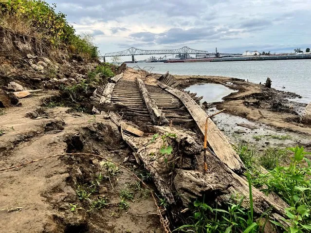 The remains of a ship lay on the banks of the Mississippi River in Baton Rouge, La., on Monday, October 17, 2022, after recently being revealed due to the low water level. The ship, which archaeologists believe to be a ferry that sunk in the late 1800s to early 1900s, was spotted by a Baton Rouge resident walking along the shore earlier this month. (Photo by Sara Cline/AP Photo)