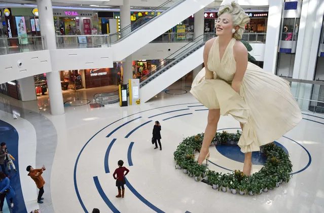 A massive, 8 metre tall sculpture of Marilyn Monroe, frozen with her dress blowing up, was on display at a shopping mall in downtown Dalian city, northeast China's Liaoning province, on Tuesday, November 14, 2017. The sculpture is a replica of Seward Johnson's Forever Marilyn in Chicago. (Photo by Imagine China/Rex Features/Shutterstock)