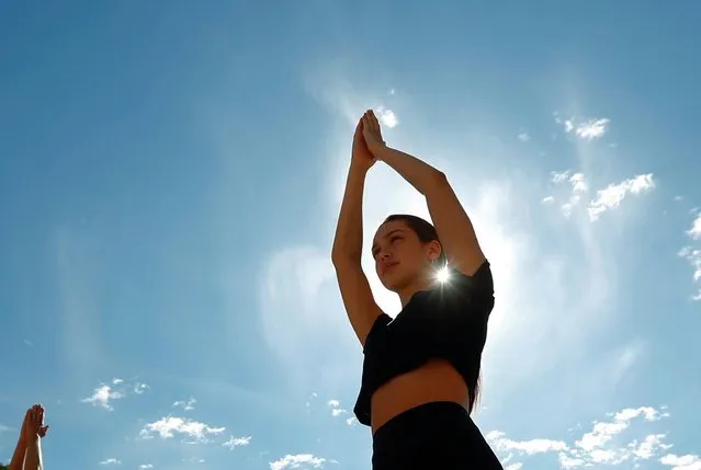A participant performs yoga during a live broadcast marking World Yoga Day in Brussels, Belgium on June 21, 2020. (Photo by Francois Lenoir/Reuters)