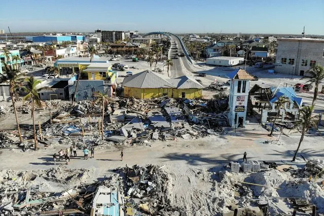 Remains of destroyed restaurants, shops and other businesses are seen almost one month after Hurricane Ian landfall in Fort Myers Beach, Florida, U.S., October 26, 2022. (Photo by Marco Bello/Reuters)