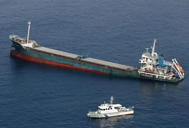 This aerial photo shows Belize-registered cargo ship Xin Hai 99, after a collision, off Kushimoto, Wakayama prefecture, southwestern Japan, Saturday, August 20, 2022. A Japanese chemical tanker ship crashed into the cargo ship off the coast of southwestern Japan, the coast guard said Saturday. (Photo by Kyodo News via AP Photo)