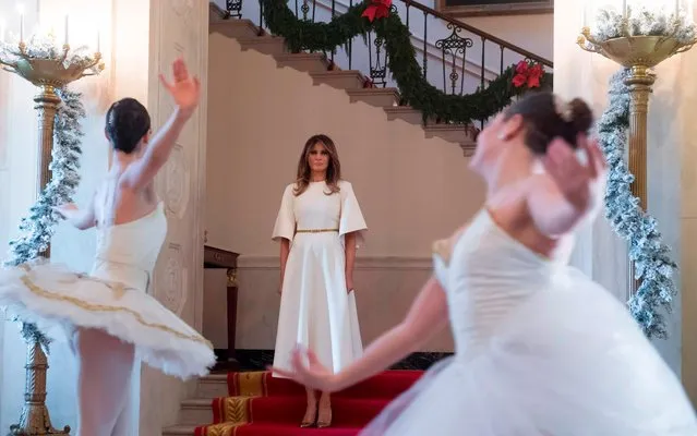 US First Lady Melania Trump watches ballerinas perform in the Grand Foyer as she tours Christmas decorations at the White House in Washington, DC, November 27, 2017. (Photo by Saul Loeb/AFP Photo)